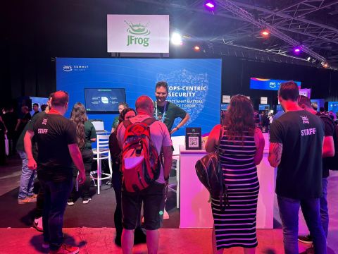 JFrog booth presentation at AWS Summit conference with engaged audience learning about DevOps security